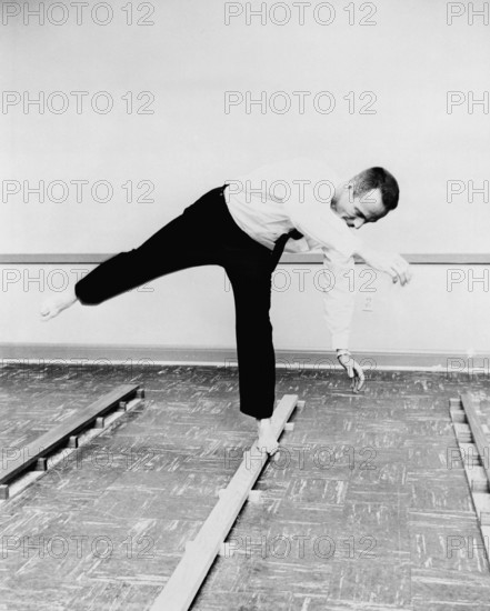 S61-04570 (1961) --- Astronaut M. Scott Carpenter s balance mechanism performance is tested by his walking on a narrow b