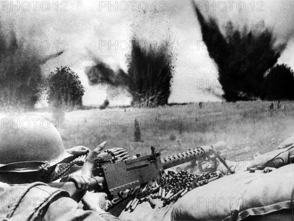 Vietnam: U.S. Air Force bombs create a curtain of flying shrapnel and debris barely 200 feet beyond the perimeter of Khe