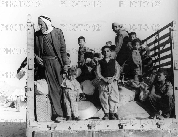 Israel / Palestine: Palestinian refugees driven from their homes by Israeli forces ride into exile in the back of a truc