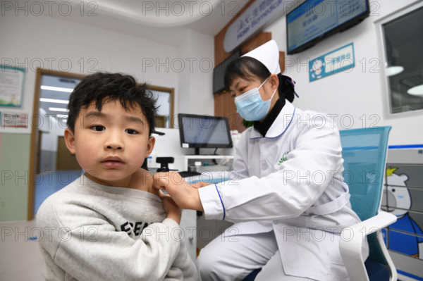 Vaccination Services in Guiyang GUIYANG, CHINA - MARCH 14, 2024 - A medical worker inoculated a child with inactivated h