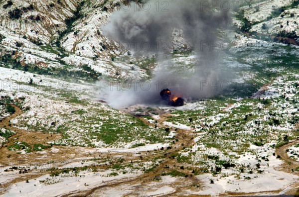 RECORD DATE NOT STATED Smoke and dust rise into the air as several bombs dropped by a Navy aircraft explode in the impac