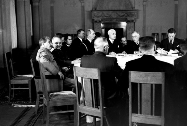WW2: Conference in session; Stalin listening to Maisky on the left, on the right is President F D Roosevelt, Hopkins an