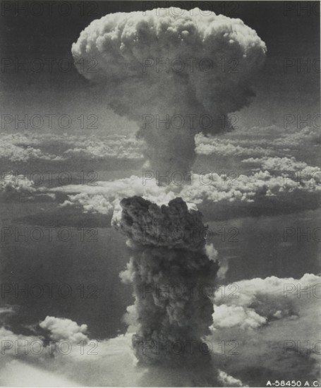 Atomic bomb over Nagasaki, Japan Nagasaki, Japan under atomic bomb attack August 9, 1945. Atomic bomb mushroom cloud ov