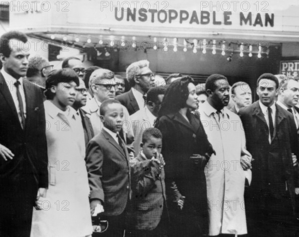 A cinema bill provides an ironic background during the march for slain civil rights leader Dr Martin