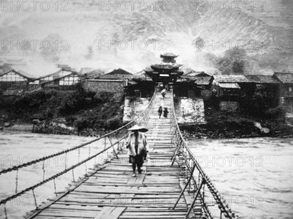 RECORD DATE NOT STATED China: Muleteers crossing the Luding Bridge over the Dadu River in Luding County, Garze Tibetan A