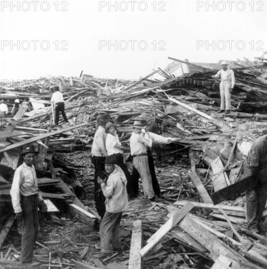 USA: The 1900 Galveston Hurricane. Relief party working at Avenue P and Tremont Street , 1900 The Hurricane of 1900 made