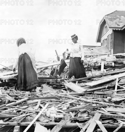 USA: The 1900 Galveston Hurricane. Two women trying to find where their home stood , 1900 The Hurricane of 1900 made lan