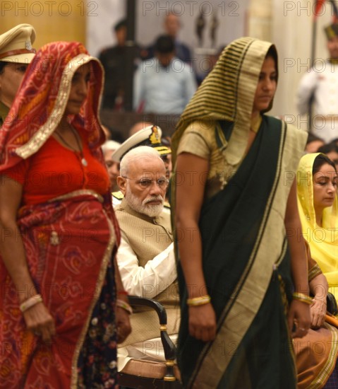 NEW DELHI, INDIA MARCH 14: Prime Minister Narendra Modi looks on as the mother and wife of late Rajendra Kumar Nain, Ce