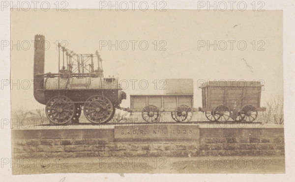 RECORD DATE NOT STATED  Locomotive with trailers on a pedestal, anonymous, 1878 - 1890 photograph On a brick base is a s