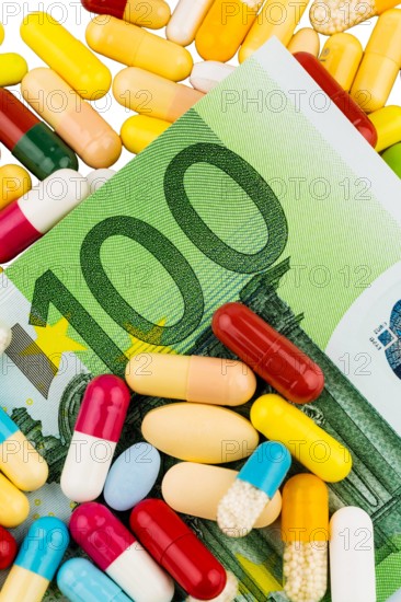 Colourful pills on a 100 Euro bills