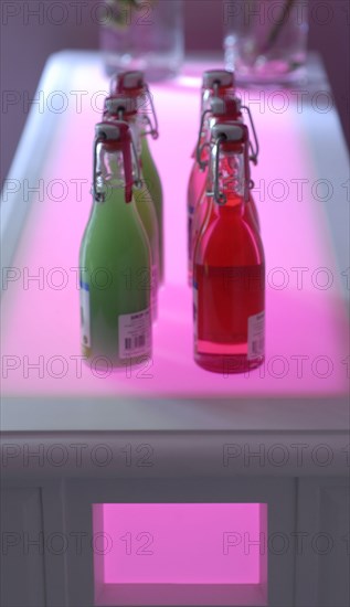 Meal in pink and green theme: bottles of syrup