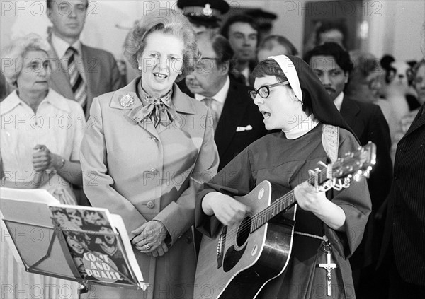 Prime Minister Margaret Thatcher  visits Toynbee Hall in the East End,  singing with a nun
July 1980