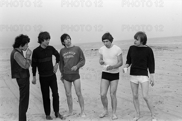 Rolling Stones. Bill Wyman, Mick Jagger, Keith Richards, Charlie Watts and Brian Jones seen here posing on Malibu beach. According to the photographers " The bpys had some hamburgers and played football and were happy to be beside the sea" However it was too cold to go swimming. During the band's first US tour, 4th June 1964