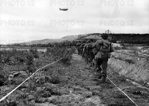 American infantrymen move along a taped path through a German minefield after their beach landing in Normandy.
WW2 1944 
1940s