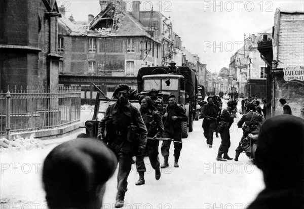World War Two - Second World War - British troops (paratroops) pass through a French town following the D-Day invasion of Normandy.
 
June 1944