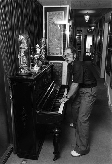 Sir Elton John in his new £50,000  mansion in Camberley, Surrey 
Playing his upright piano
June 1974