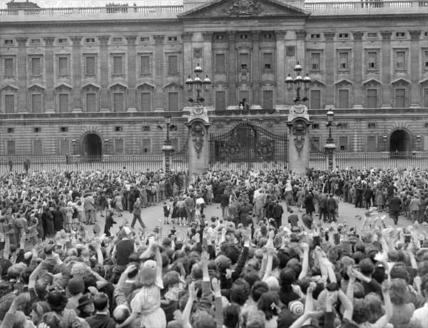 At 3pm on 8 May 1945, Prime Minister, Winston Churchill announced that the war in Europe would end at midnight. London erupted into a massive chorus of jubilation and celebration. Mr Churchill was greeted by huge cheering crowds wherever he went and the King was kept busy by a crowd outside Buckingham Palace who made him keep returning to the balcony to receive their accolades. Even his own daughters, escorted by Palace guards, joined the crowd in shouting for the King. All licensing laws in the capital were revoked for the evening and the celebrations went on well into the small hours.
Our Picture Shows: King Queen and Princesses on balcony of Buckingham Palace waving to the crowds gathers around the gates 
May 1945
1940s
