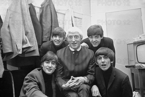Disc Jockey Jimmy Saville pictured with Liverpool pop group The Beatles at Finsbury Park Astoria in London.
The Beatles and Saville appeared together on the first ever Top Of The Pops programme on New Year's Day, 1964.
Beatles are left to right, back row: drummer Ringo Starr and bass guitarist Paul McCartney.
Front: John Lennon and George Harrison.
11th January 1964.
