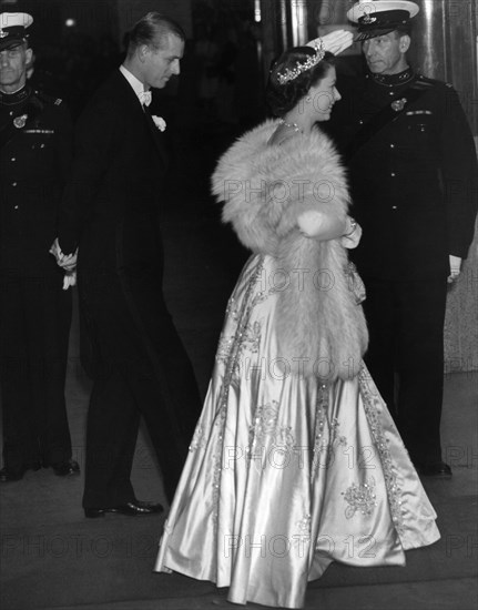 Princess Elizabeth wearing an elegant long dress and fur stoll attends an the premiere of the film "The Lady With A Lamp" accompanied by her husband Prince Philip, the Duke of Edinburgh.
22nd September 1951.