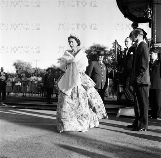 Queen Elizabeth II and Prince Philip, Duke of Edinburgh pictured during the Royal tour of Canada. The Queen, in evening gown and ermine wrap leaves the Royal Train at Stratford to attend the Stratford Shakespearian Festival. Stratford, Ontario, Canada. 2nd July 1959.