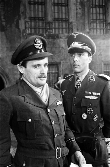 Actors David McCallum (left) and Anthony Valentine on the film set during filming of 'Colditz', the BBC TV series. David McCallum played the part of Flight Lieutenant Simon Carter and Anthony Valentine played Major Horst Mohn, 2nd in command. Ealing Studios, London, 7th September 1973.