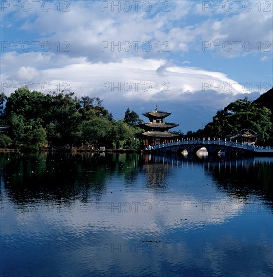 Traditional Chinese pavilion by a pond, China