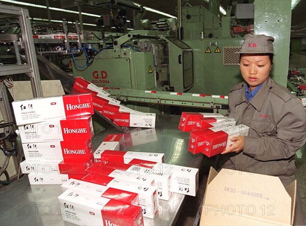 A female worker packs Honghe cigarette in the workshop of Honghe Tobacco Factory in Yunnan, China