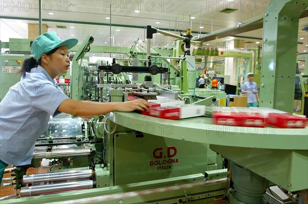 A female worker packs Honghe cigarette in the workshop of Honghe Tobacco Factory in Yunnan,China