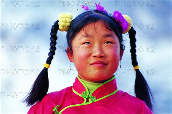 A portrait of a pigtailed girl from Yangjiagou,Mizhi,Shaanxi Province,China