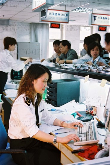 A female clerk working on the counter of Waigaoqiao customhouse, Shanghai,China