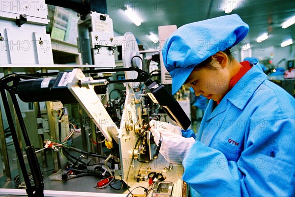 A female worker works in workshop of electornic plant of Zhangjiang industrial district, Shanghai,China