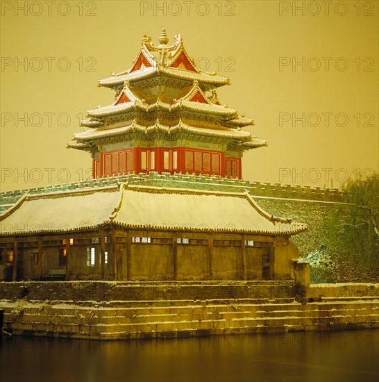 a corner tower of the Forbidden City in snow,Beijing,China