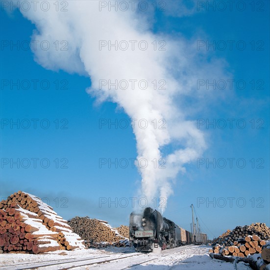 A steam train running through a timber mill(Northeast China)