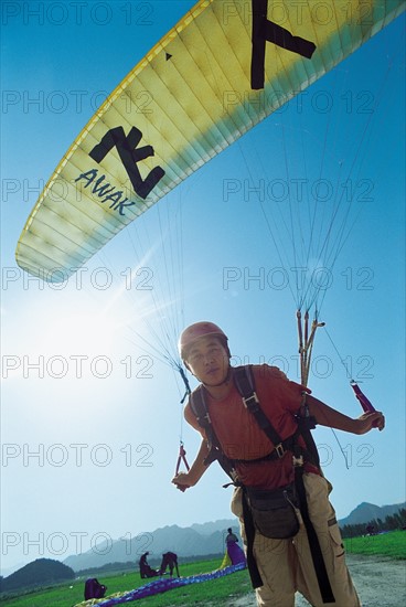A man prepares to glide(China)