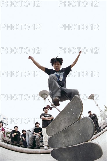 A Chinese boy play Skateboarding