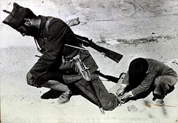 Soldier lacing up his boots