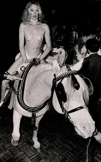 Naked female riding during one of Andy Warhol's parties
