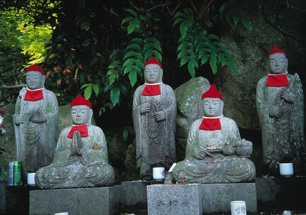 Jizou spirit guardians in a temple garden in Japan