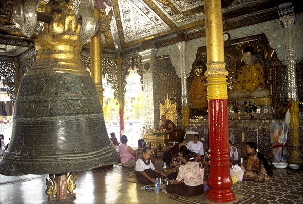 One of the world`s biggest bronze bells hands in the Shwedagon Pagoda in Yangon Myanmar
