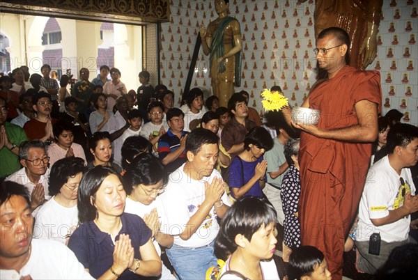 Buddhist monk sprinkles `holy water` on worshippers, Wesak Malaysia