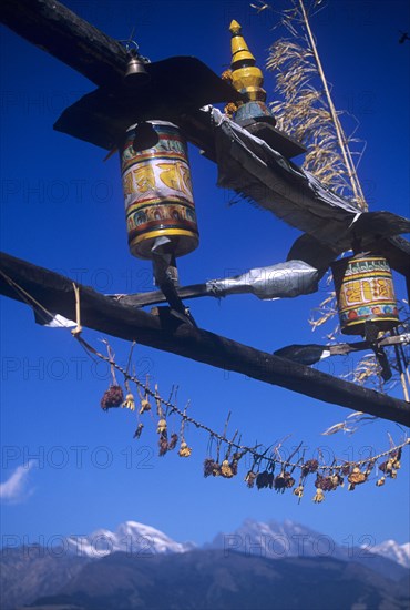 Buddhist prayer wheels turning in the wind on a temple
in Nepal