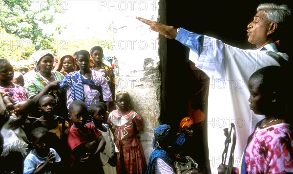 Catholic priest from Indian welcomes people into his small rural church Tanzania