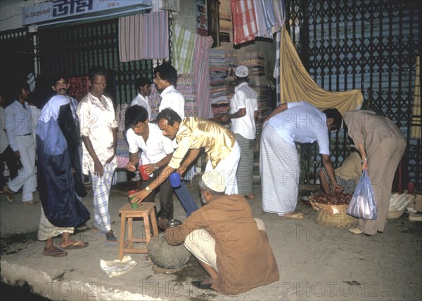 First drink at dusk after a day`s fasting in Dacca Bangladesh