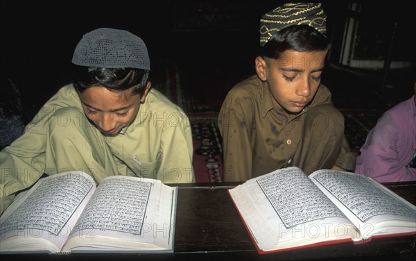 Young Pakistani boys reading the Quran