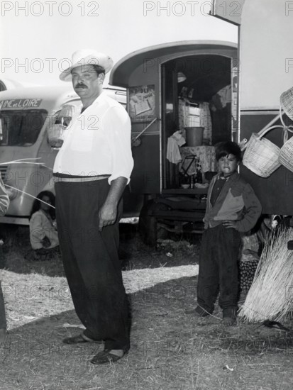 Gypsy people before a caravan