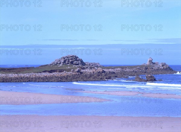 View from the D27 road, near Penfoul, towards the West, Penfoul cove, Le Coq rock and point. Tide halfway out