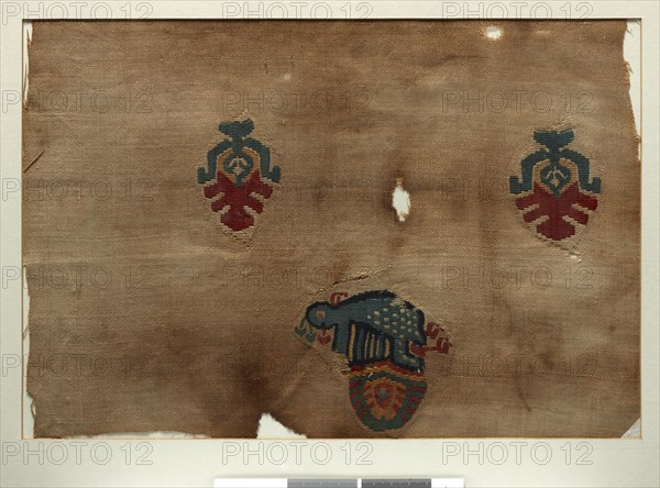 Coptic textile adorned with a peacock and two stylized trees