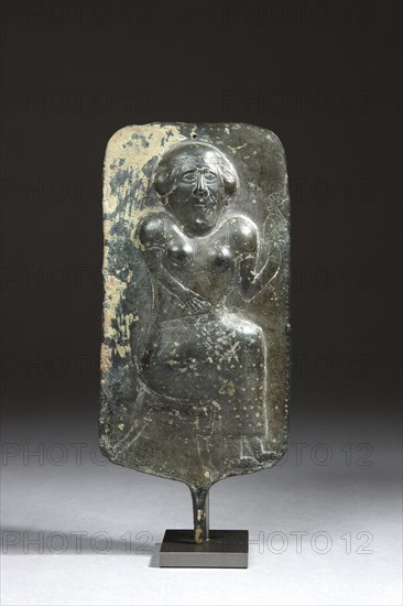 Votive plaque adorned with a seated woman