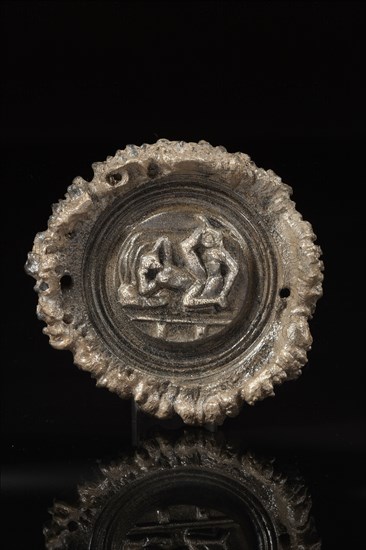 Roman phalera carved with an erotic scene