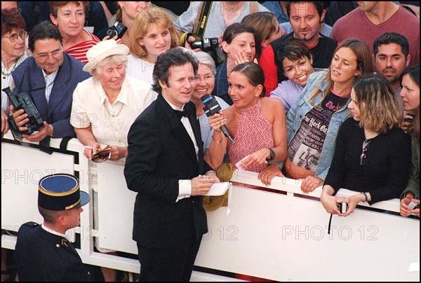 05/09/2001. 54th Cannes Film Festival: Francis Huster walking up the stairs.